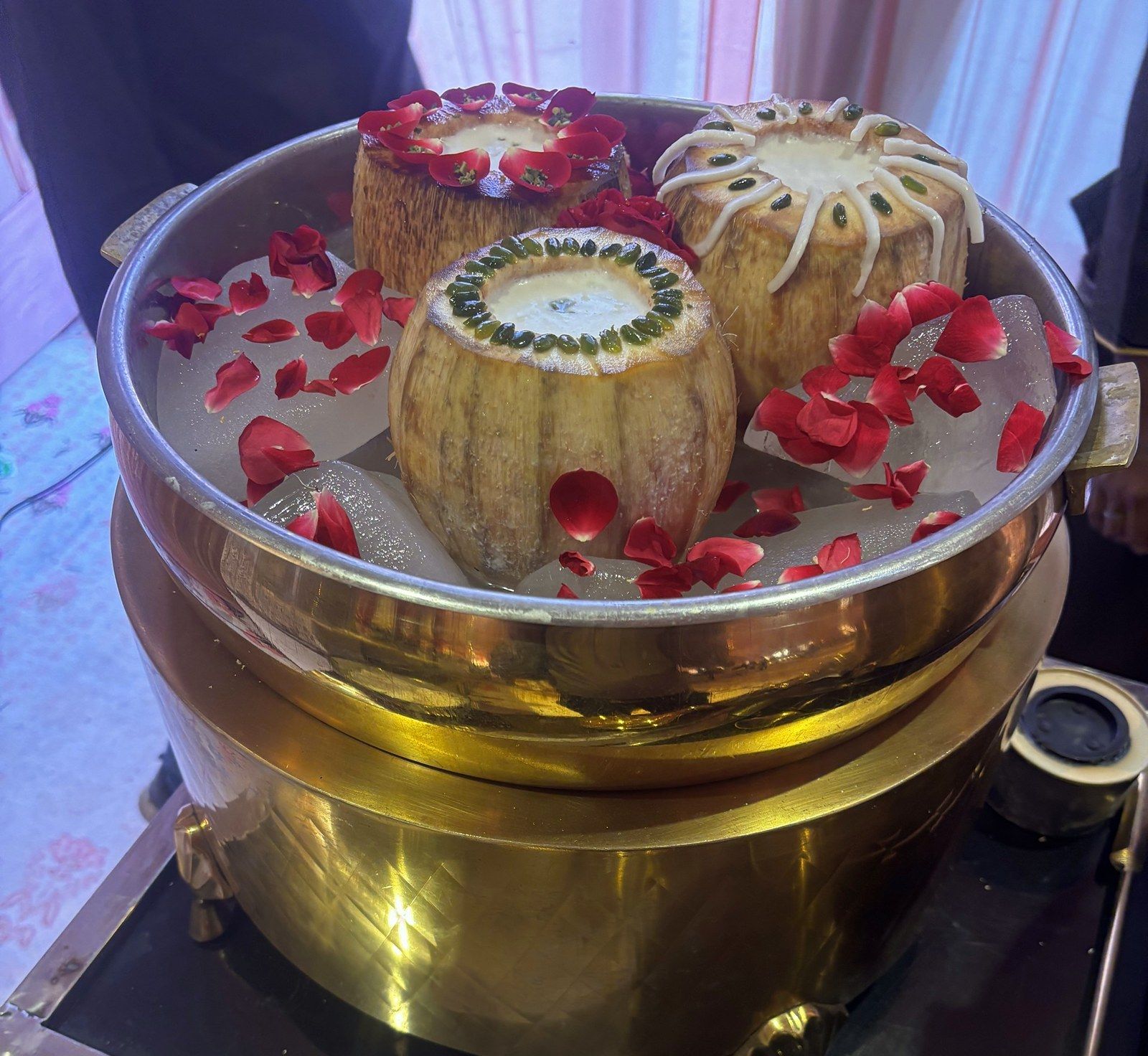 Thai coconut mawa mishri in a brass handi with rose petals
